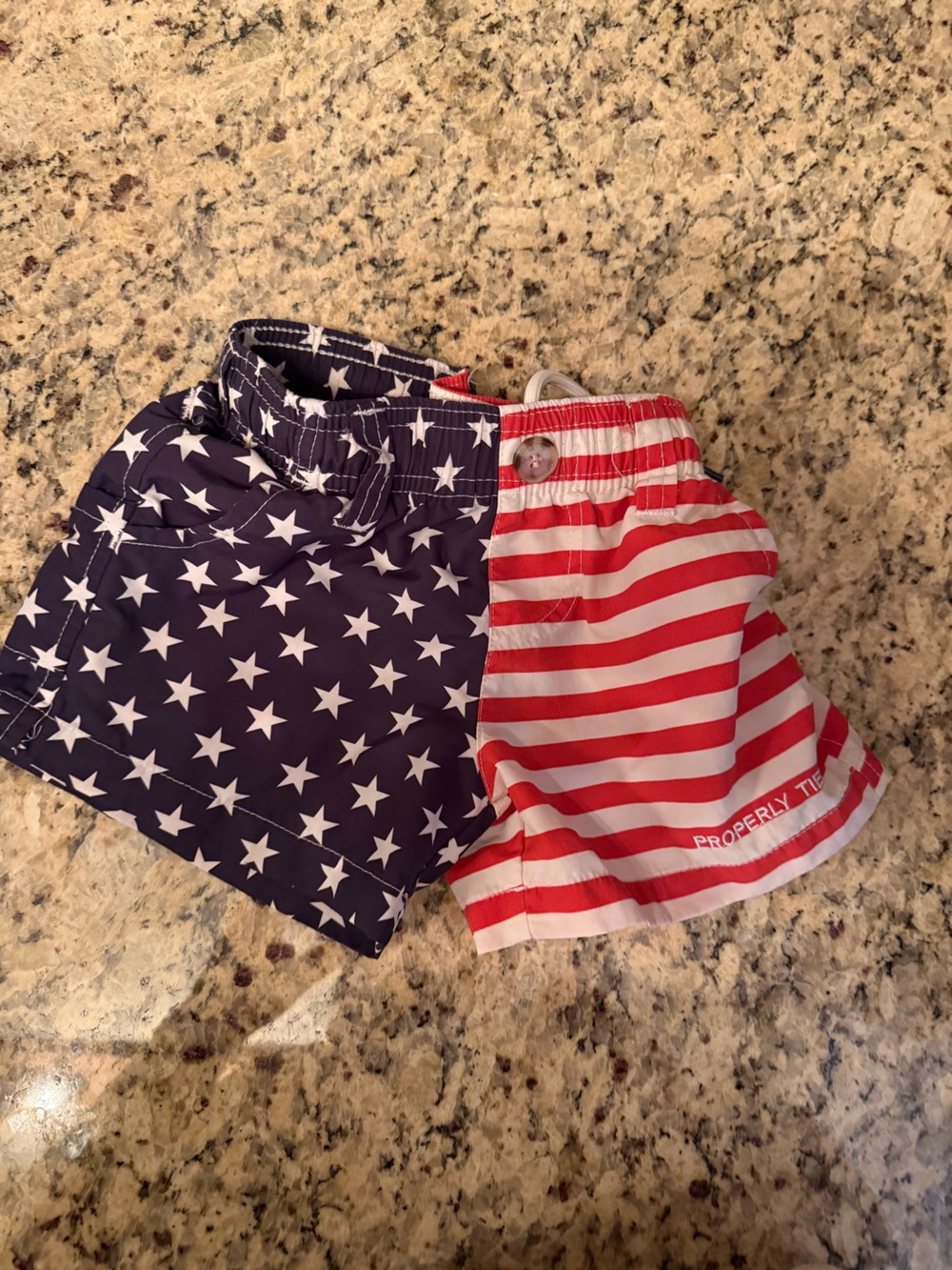 Properly tied 2T boys swim trunk USA flag